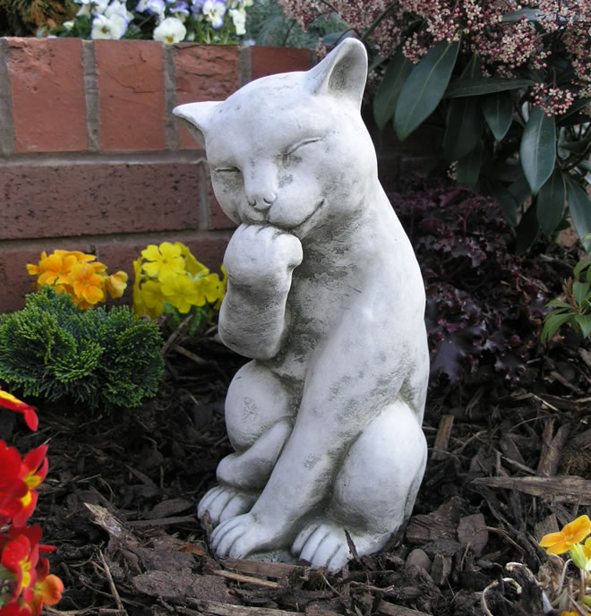 Cat In Garden. Licking Paw Stone Cat Garden