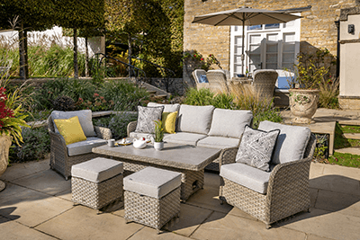 Hartman Eton 3 seat lounge set on a stone patio with a house and garden to the back