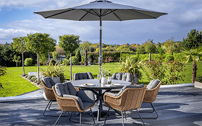 Hartman Rayo 6 seat dining set. Positioned on a wooden patio with a garden backing