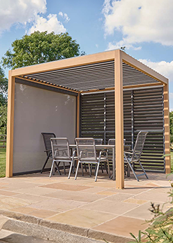 Brown framed square pergola with canopy on a lawn with trees in background