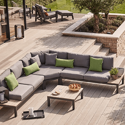 A metal Elba large low corner set. Set out on a patio in the perfect position to enjoy the rest of the garden. Dotted with other Kettler accessories to complement the luxurious set