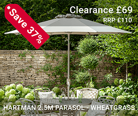 The Hartman wheatgrass 2.5m parasol with a beautiful floral background. Featuring a crank handle and tilt function.